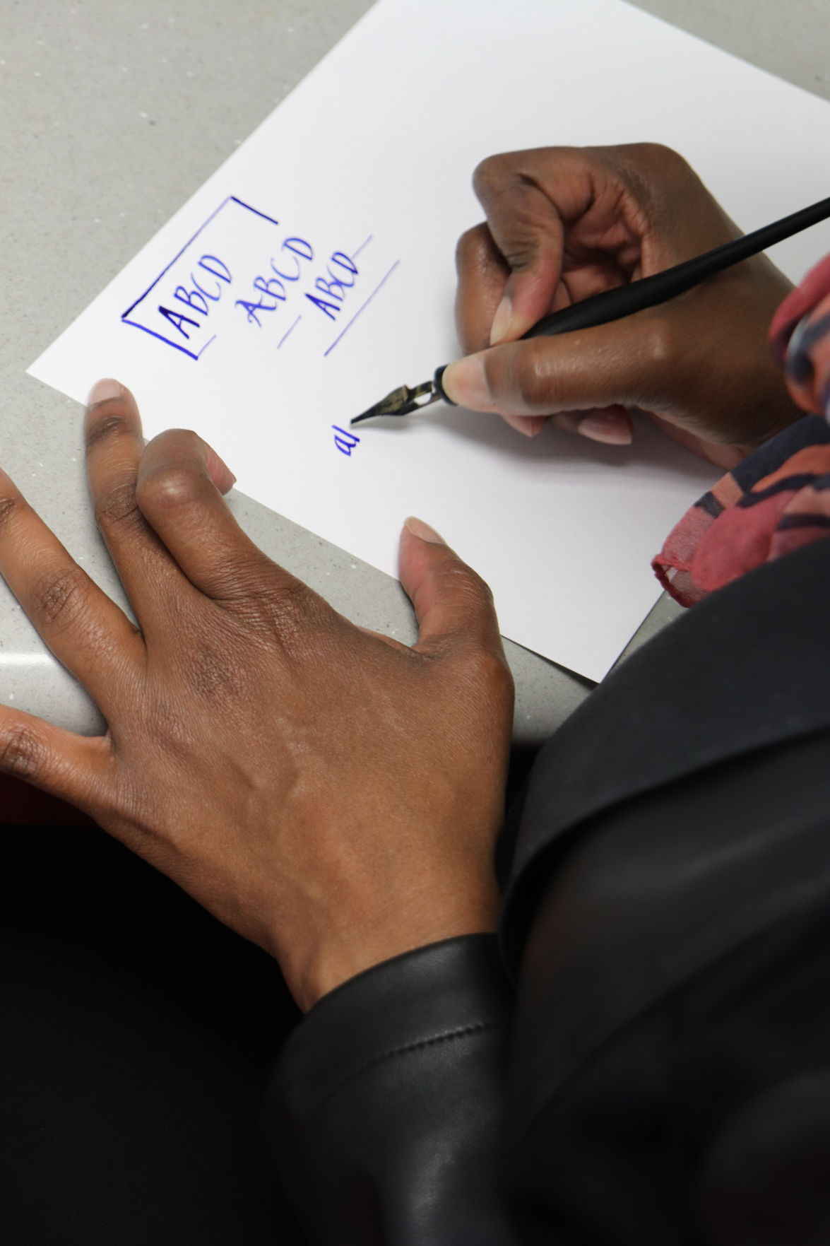 Lisa Lenoir practices hand-lettering the alphabet.